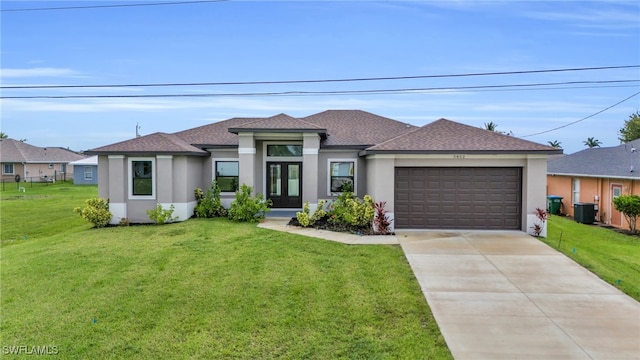 view of front facade featuring central AC unit, a garage, and a front yard