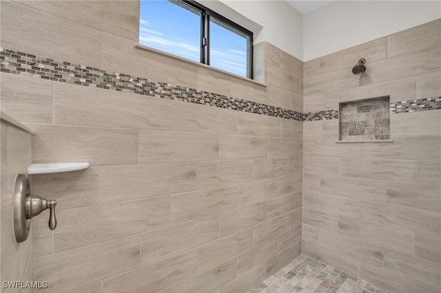 bathroom with a tile shower