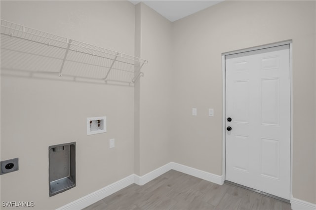 laundry room with light hardwood / wood-style floors, hookup for a washing machine, and electric dryer hookup