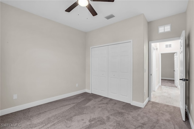 unfurnished bedroom with ceiling fan, carpet, and a closet