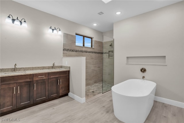 bathroom featuring shower with separate bathtub and vanity