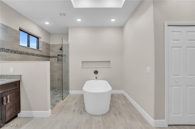 bathroom featuring independent shower and bath and vanity