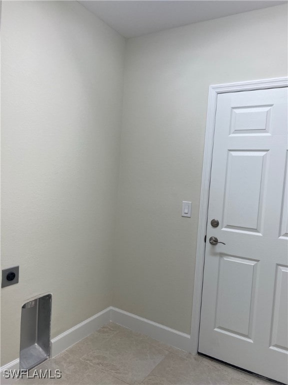 washroom featuring electric dryer hookup and light tile patterned floors