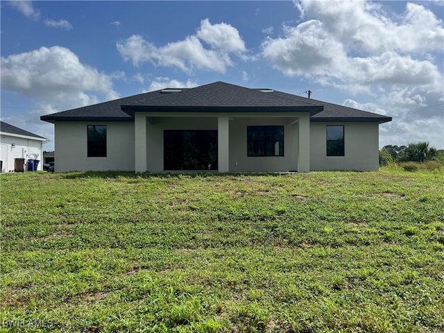 rear view of house with a lawn