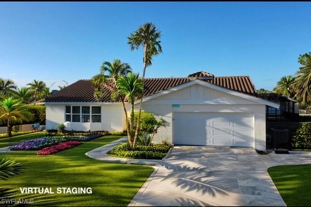 view of front of house with a garage, a front lawn, and central AC unit