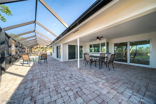 view of patio / terrace featuring glass enclosure and ceiling fan