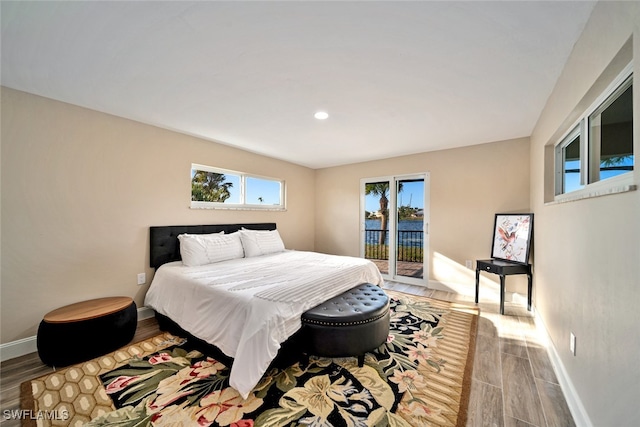 bedroom featuring hardwood / wood-style floors and access to outside