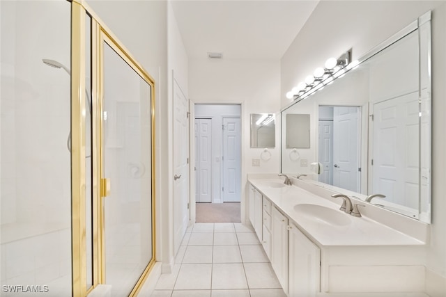 bathroom featuring vanity, tile patterned floors, and walk in shower