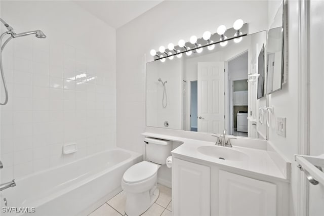 full bathroom featuring washer / dryer, toilet, tile patterned floors, tiled shower / bath, and vanity