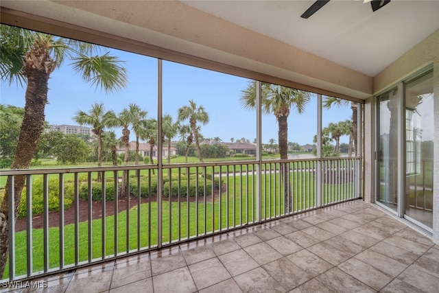 unfurnished sunroom with ceiling fan