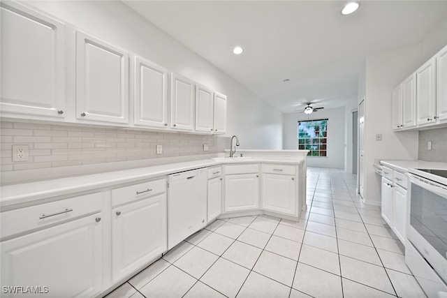 kitchen featuring white appliances, kitchen peninsula, white cabinetry, ceiling fan, and light tile patterned floors