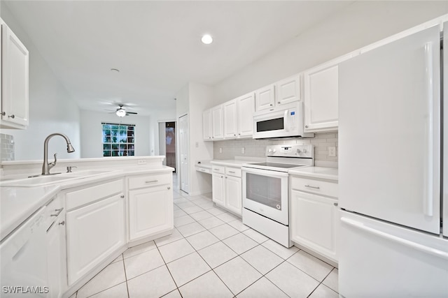 kitchen featuring decorative backsplash, sink, light tile patterned flooring, white cabinets, and white appliances