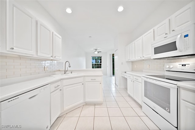 kitchen featuring white cabinets, sink, and white appliances