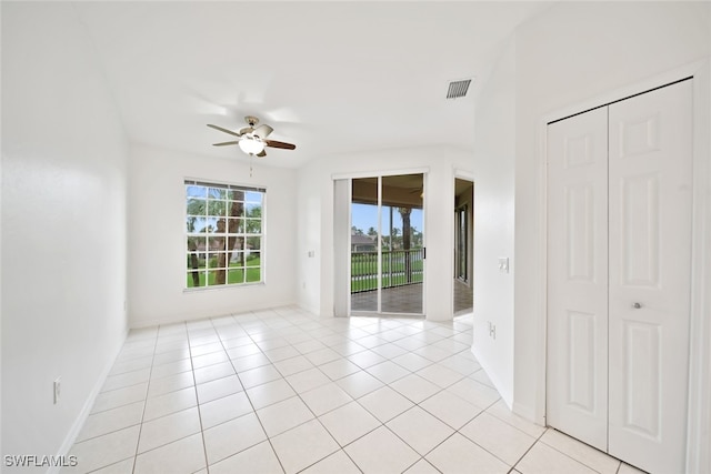 spare room featuring light tile patterned flooring and ceiling fan