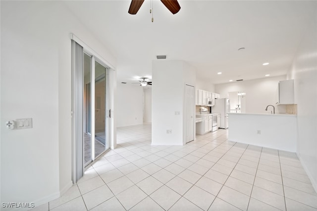 unfurnished living room with light tile patterned floors, sink, and ceiling fan