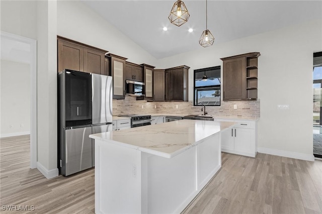 kitchen featuring stainless steel appliances, a center island, dark brown cabinets, and white cabinets