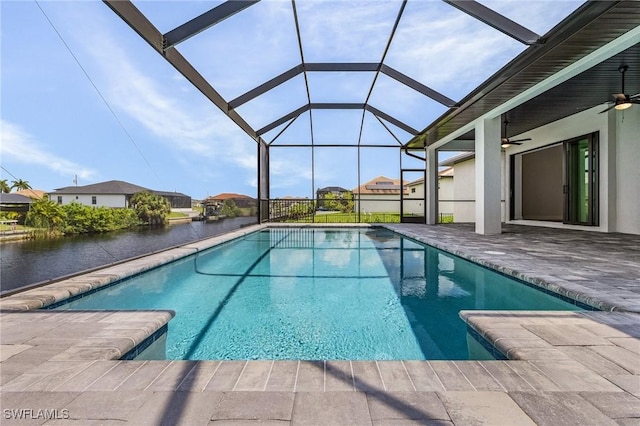 view of pool featuring a water view, ceiling fan, a lanai, and a patio area