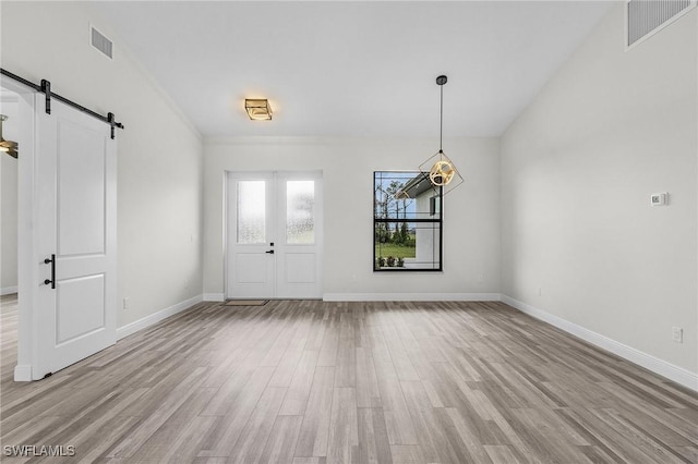 entrance foyer featuring a barn door and light hardwood / wood-style floors