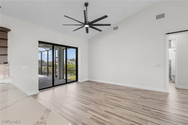 spare room featuring high vaulted ceiling, ceiling fan, and light hardwood / wood-style floors