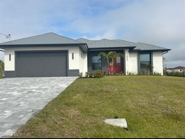 view of front of house with a garage and a front lawn