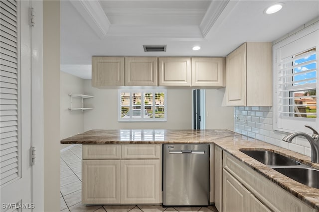 kitchen with ornamental molding, kitchen peninsula, dishwasher, and a raised ceiling