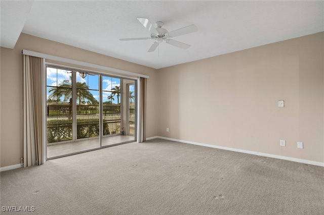 spare room with carpet, baseboards, and ceiling fan