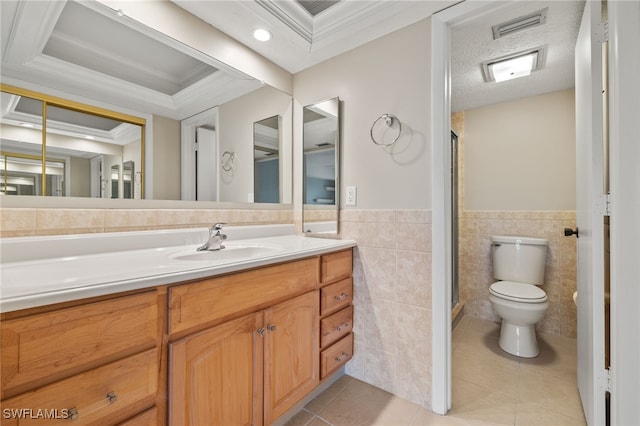 bathroom with tile walls, tile patterned floors, vanity, a tray ceiling, and toilet