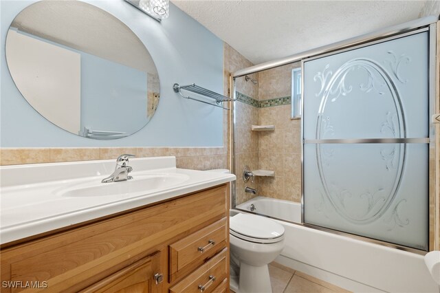 full bathroom with tile patterned floors, enclosed tub / shower combo, a textured ceiling, vanity, and toilet