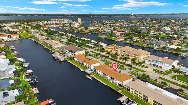 drone / aerial view with a water view and a residential view