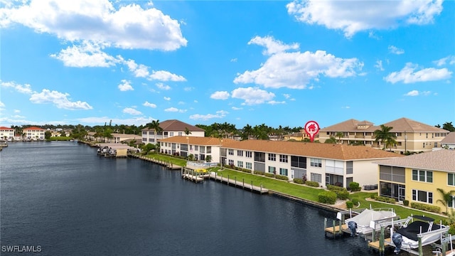 view of water feature featuring a boat dock, boat lift, and a residential view