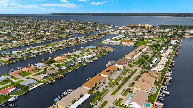 drone / aerial view featuring a water view and a residential view