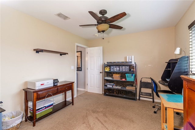 carpeted home office with ceiling fan