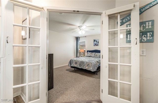 carpeted bedroom with a textured ceiling and ceiling fan