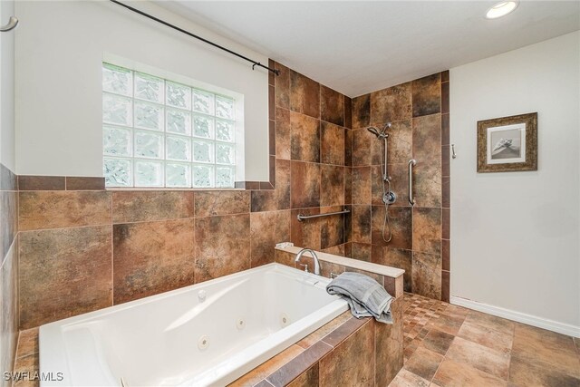 bathroom with tile patterned flooring and separate shower and tub