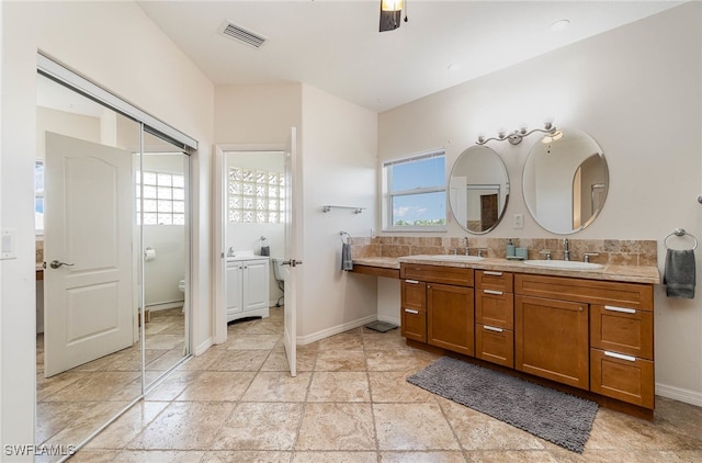 bathroom with tile patterned floors, vanity, backsplash, and toilet