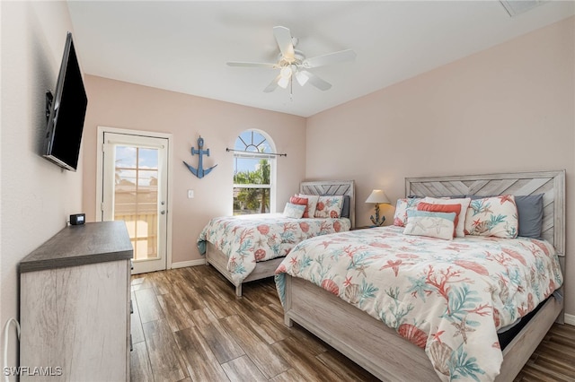 bedroom with ceiling fan, dark hardwood / wood-style flooring, and access to exterior