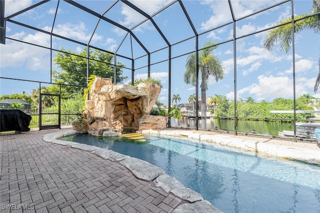 view of swimming pool with a patio area and a lanai