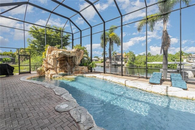 view of swimming pool featuring glass enclosure, a patio, and pool water feature