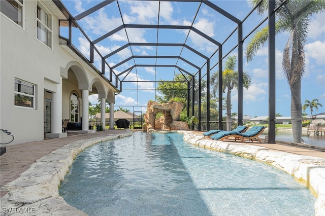 view of pool featuring a patio area, a lanai, and pool water feature