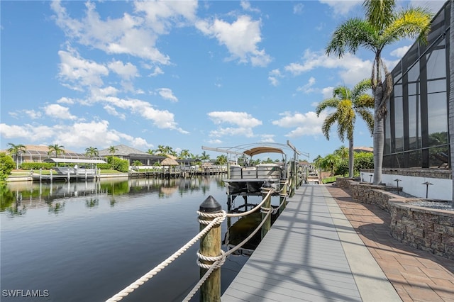 dock area featuring a lanai and a water view