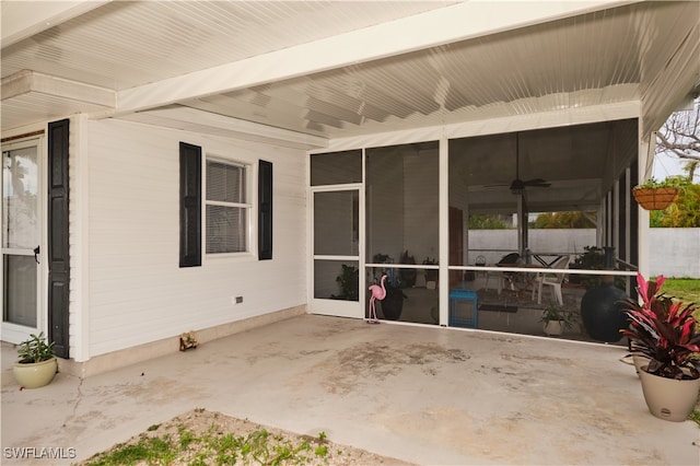 view of patio / terrace with ceiling fan and a sunroom