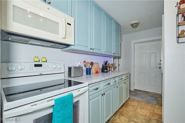 kitchen with white appliances and light tile patterned floors