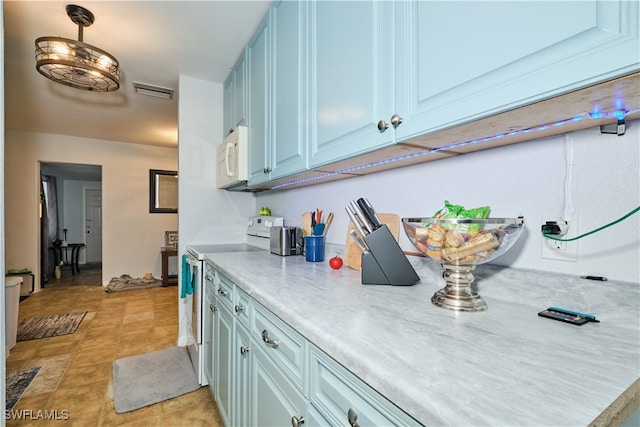 kitchen with pendant lighting, electric stove, and light tile patterned floors