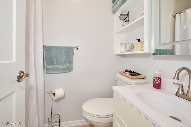 bathroom featuring toilet and vanity