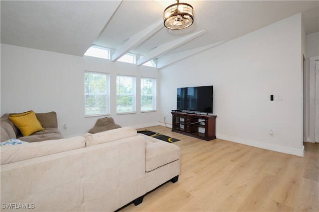 living room featuring light hardwood / wood-style flooring and lofted ceiling with beams