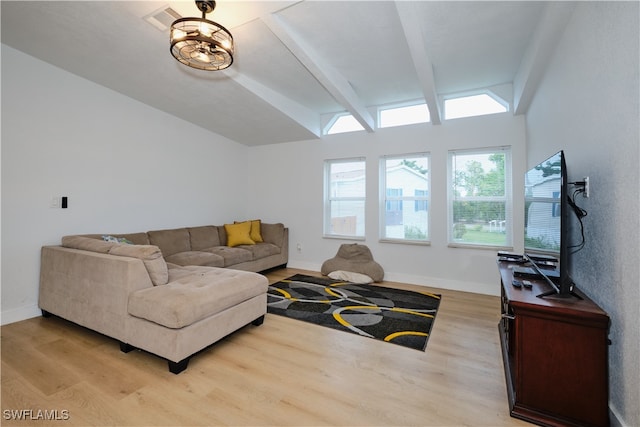 living room with light wood-type flooring and lofted ceiling with beams