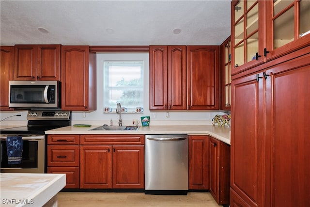 kitchen featuring sink, stainless steel appliances, and light hardwood / wood-style floors