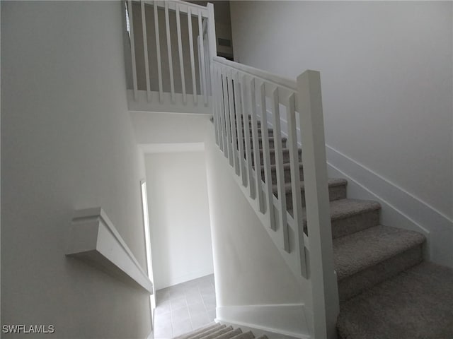 stairs with tile patterned flooring