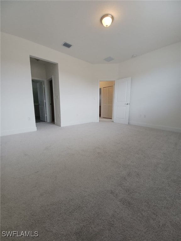 unfurnished room with light carpet