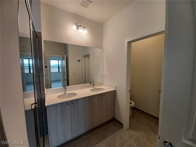 bathroom with tile patterned floors, vanity, and toilet